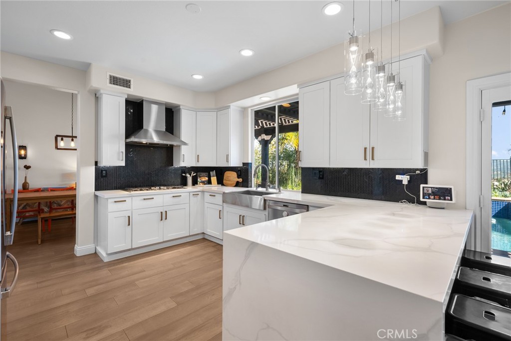 25742 Lewis Way Stevenson Ranch, CA 91381 - Photo 24 of 66 a large kitchen with kitchen island a sink stainless steel appliances and cabinets