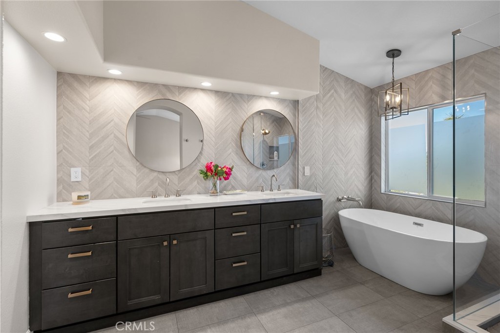 25742 Lewis Way Stevenson Ranch, CA 91381 - Photo 32 of 66 a bathroom with a tub sink and mirror
