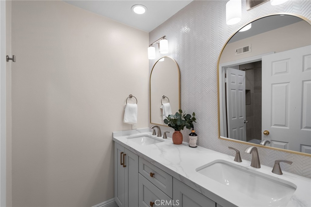 25742 Lewis Way Stevenson Ranch, CA 91381 - Photo 42 of 66 a bathroom with double vanity sinks and a mirror