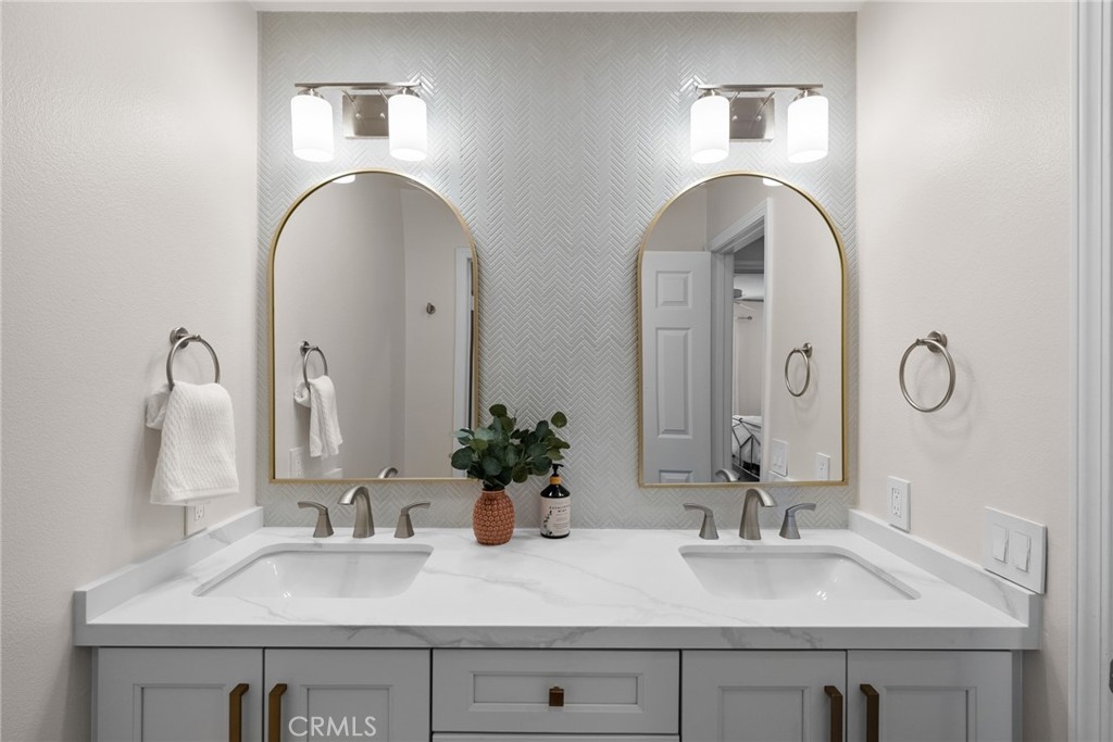 25742 Lewis Way Stevenson Ranch, CA 91381 - Photo 43 of 66 a bathroom with double vanity sinks and a mirror