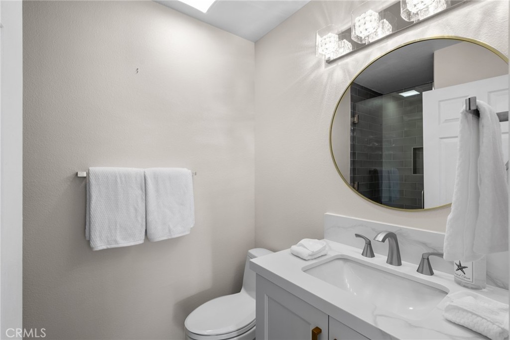 25742 Lewis Way Stevenson Ranch, CA 91381 - Photo 49 of 66 a bathroom with a granite countertop sink mirror and toilet