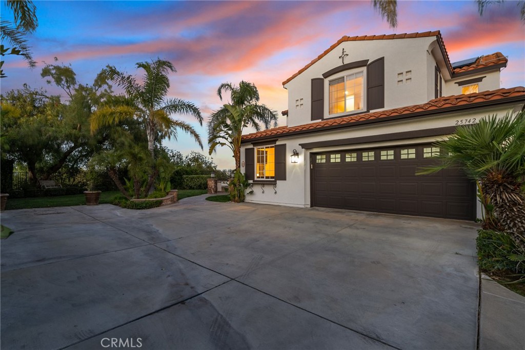 25742 Lewis Way Stevenson Ranch, CA 91381 - Photo 66 of 66 a front view of a house with a yard and garage