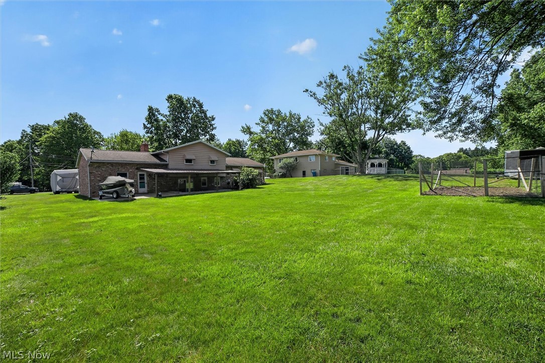 5862 Canterbury Road New Franklin, OH 44319 - Photo 33 of 45 Viewing from NE corner towards house with concrete pad for boat, enclosed garden area to right.