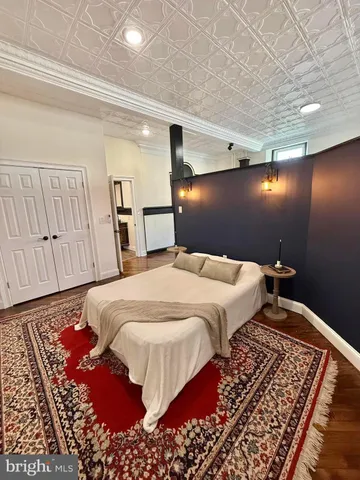 a bedroom with a large bed and a rug