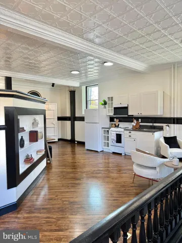 a kitchen with stainless steel appliances kitchen island granite countertop a stove and a microwave