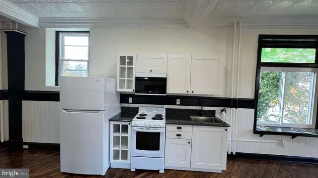 a kitchen with stainless steel appliances a stove top oven and a refrigerator