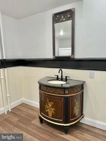 a white toilet sitting next to a bathroom sink and a tub