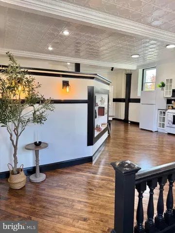a view of living room with furniture and wooden floor