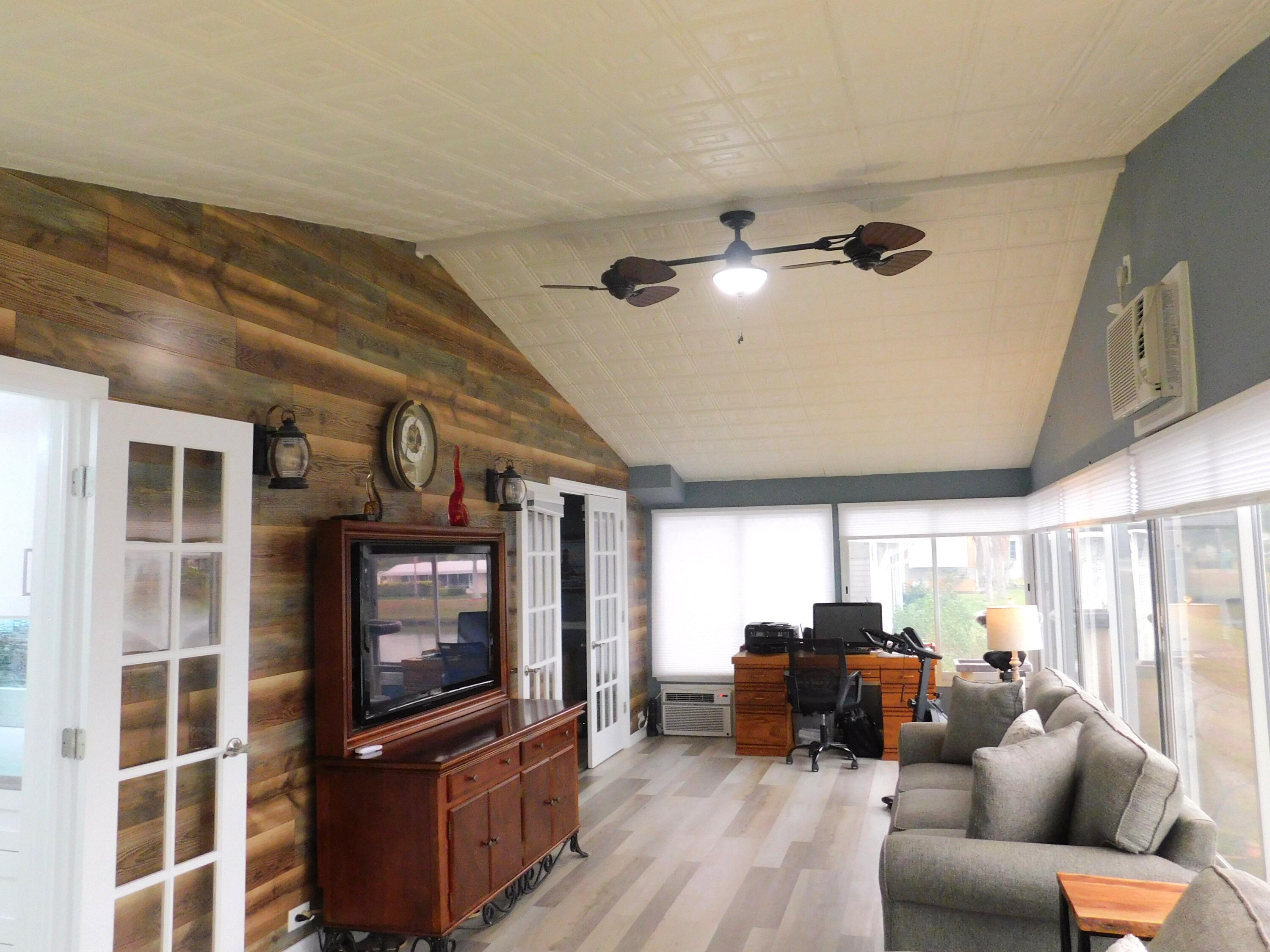 529 Hemingway Terrace, Unit 8 Fort Pierce, FL 34982 - Photo 15 of 24 a living room with furniture a flat screen tv and kitchen view