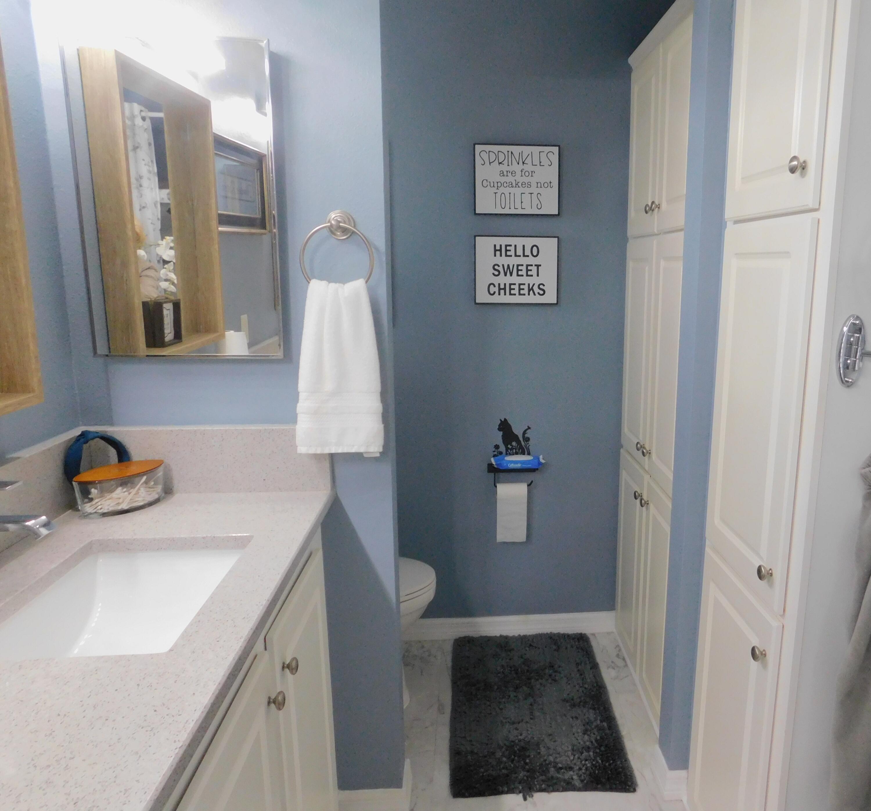 529 Hemingway Terrace, Unit 8 Fort Pierce, FL 34982 - Photo 21 of 24 a bathroom with a sink a toilet and vanity