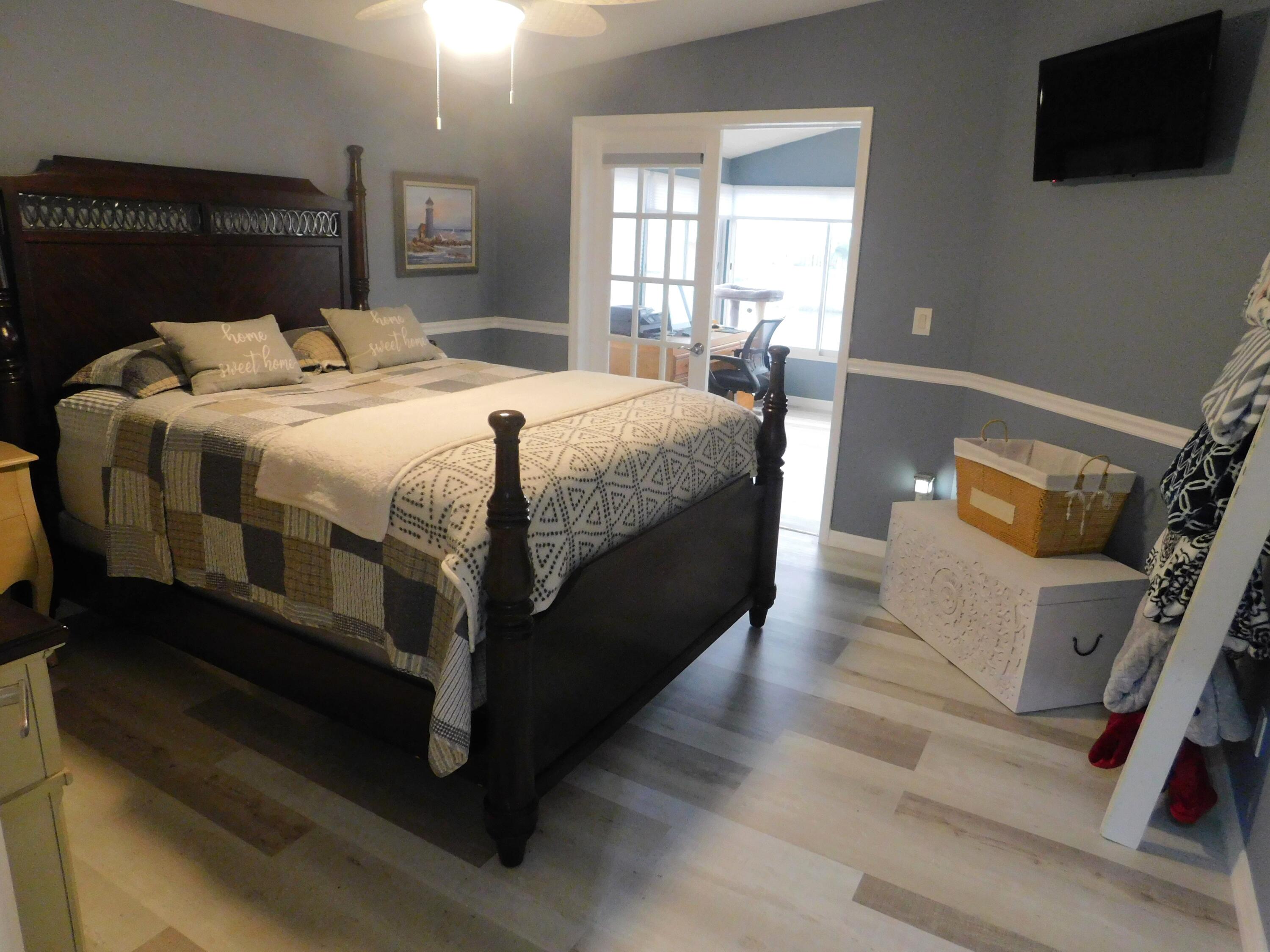 529 Hemingway Terrace, Unit 8 Fort Pierce, FL 34982 - Photo 23 of 24 a bed sitting in a bedroom and view of living room