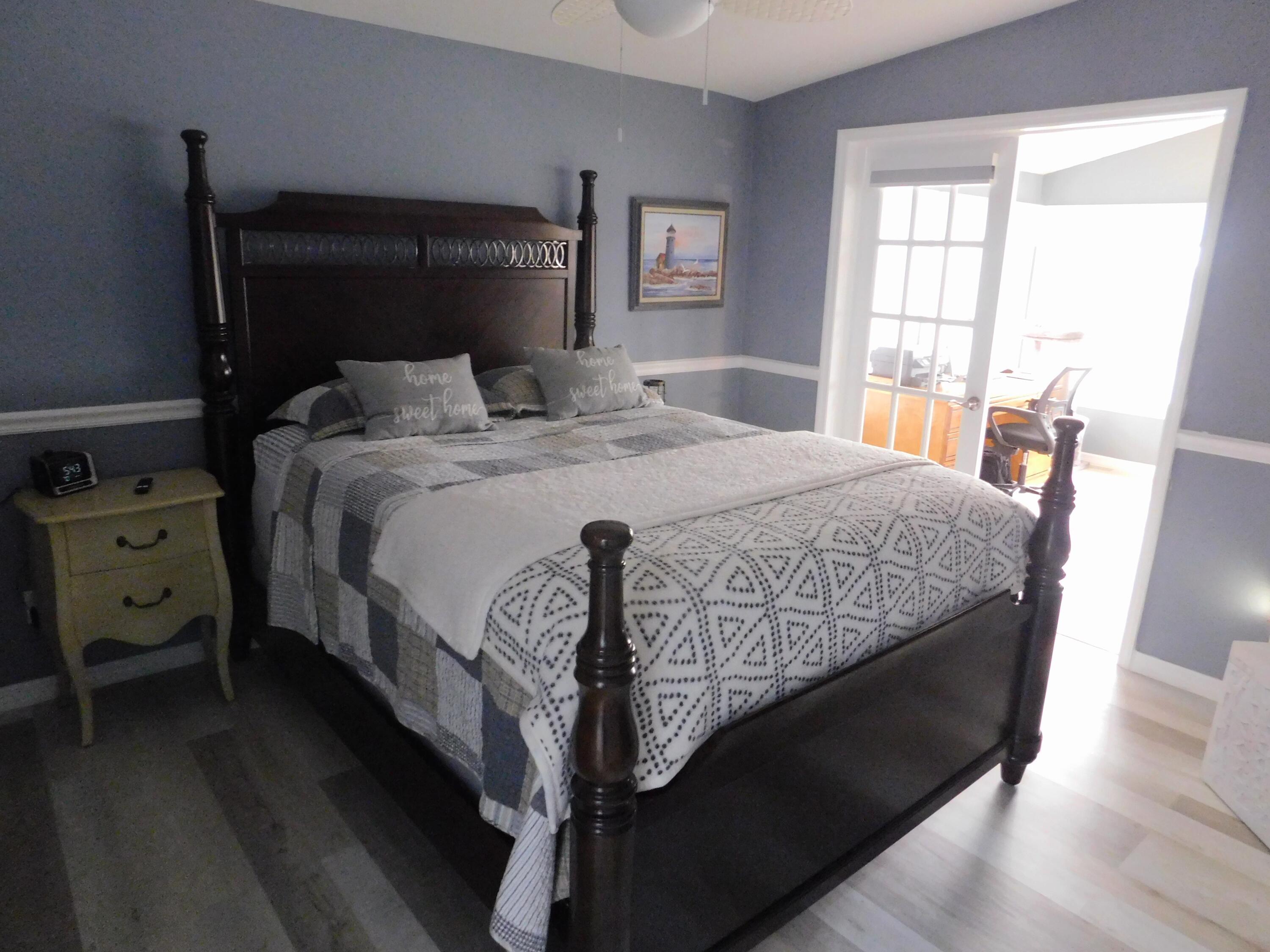 529 Hemingway Terrace, Unit 8 Fort Pierce, FL 34982 - Photo 24 of 24 a bedroom with a bed and wooden floor