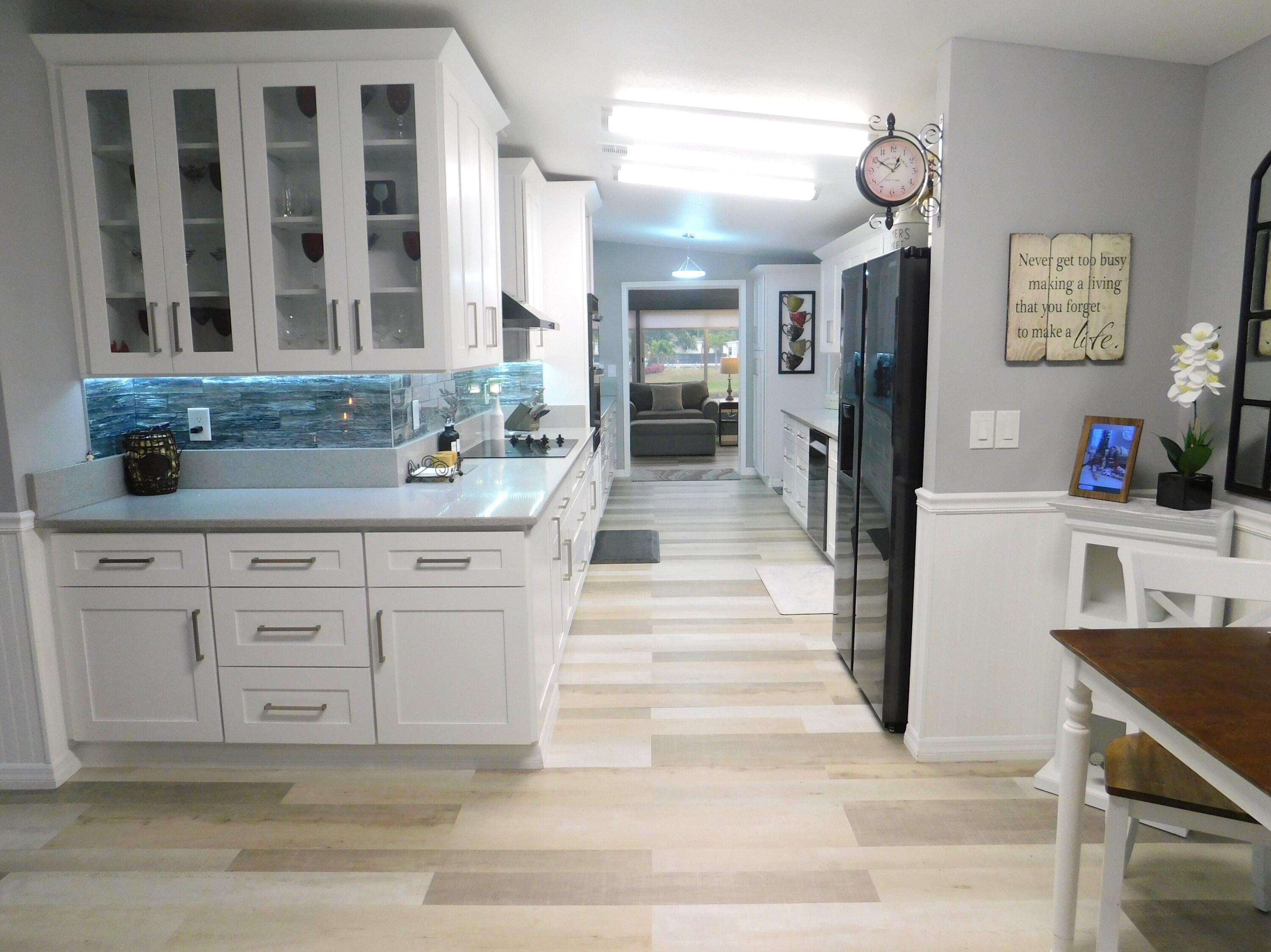 529 Hemingway Terrace, Unit 8 Fort Pierce, FL 34982 - Photo 3 of 24 a kitchen with stainless steel appliances kitchen island granite countertop a sink and cabinets