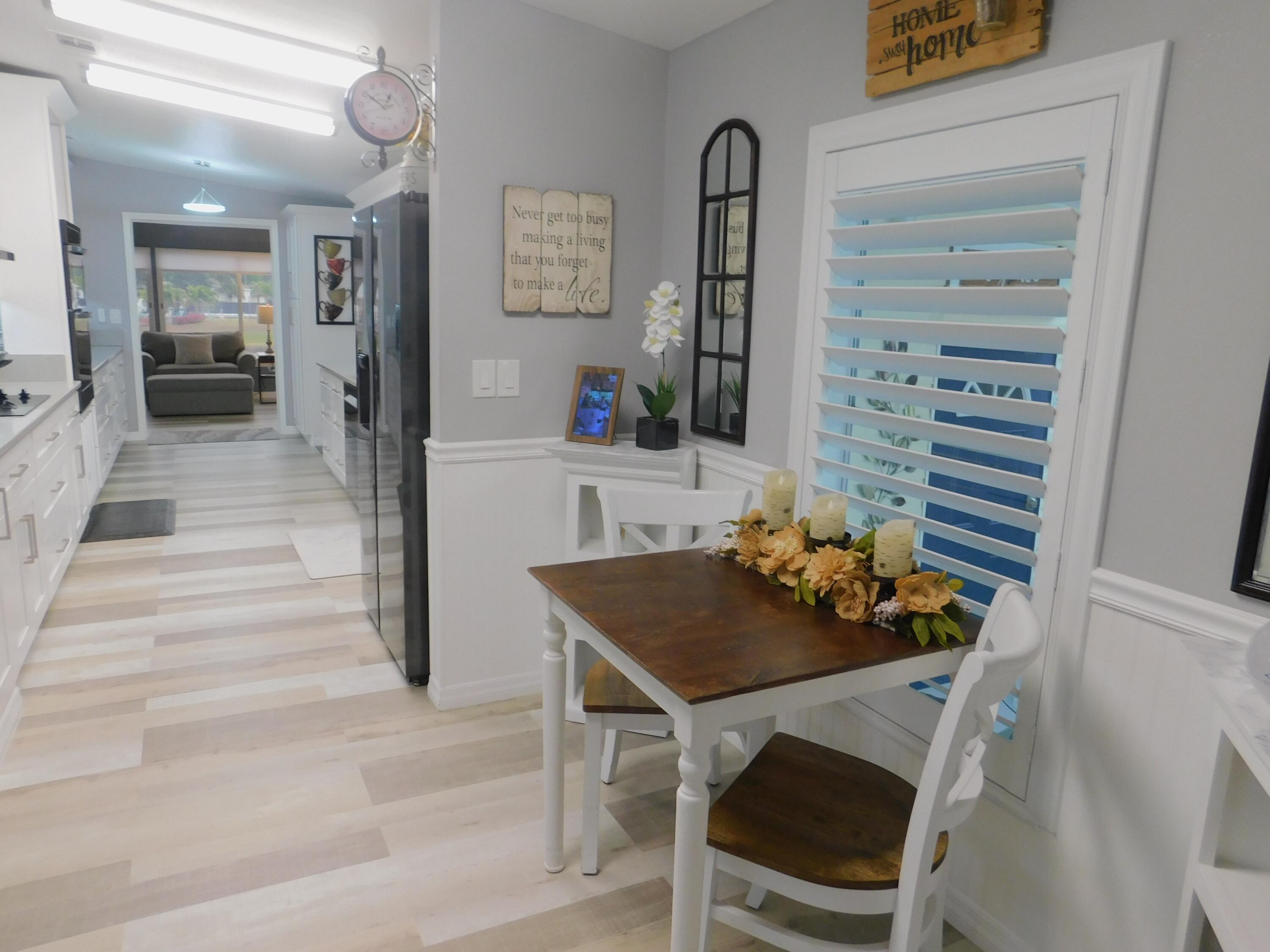 529 Hemingway Terrace, Unit 8 Fort Pierce, FL 34982 - Photo 5 of 24 a dining room with furniture and wooden floor
