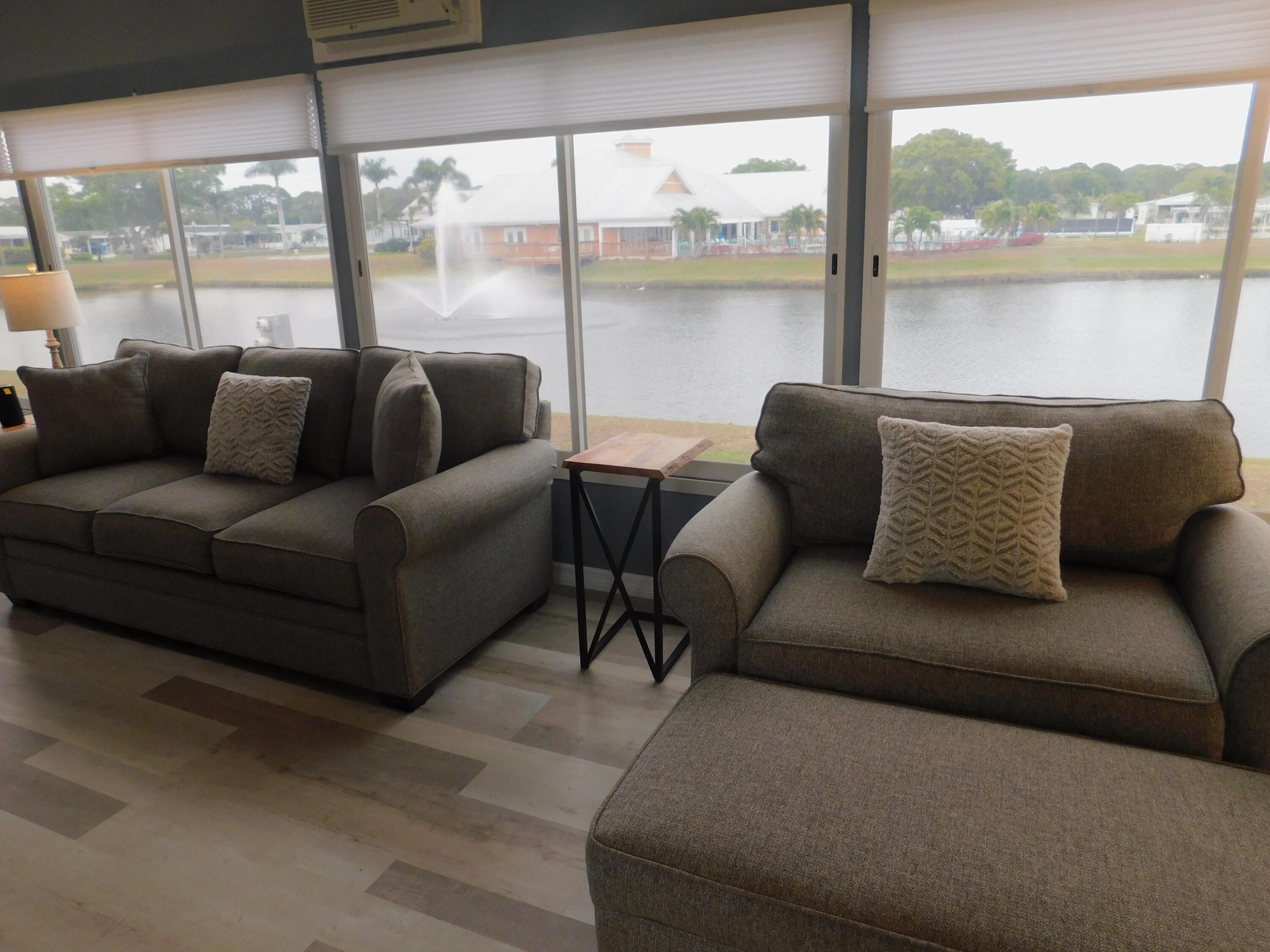 529 Hemingway Terrace, Unit 8 Fort Pierce, FL 34982 - Photo 10 of 24 a living room with furniture and a large window