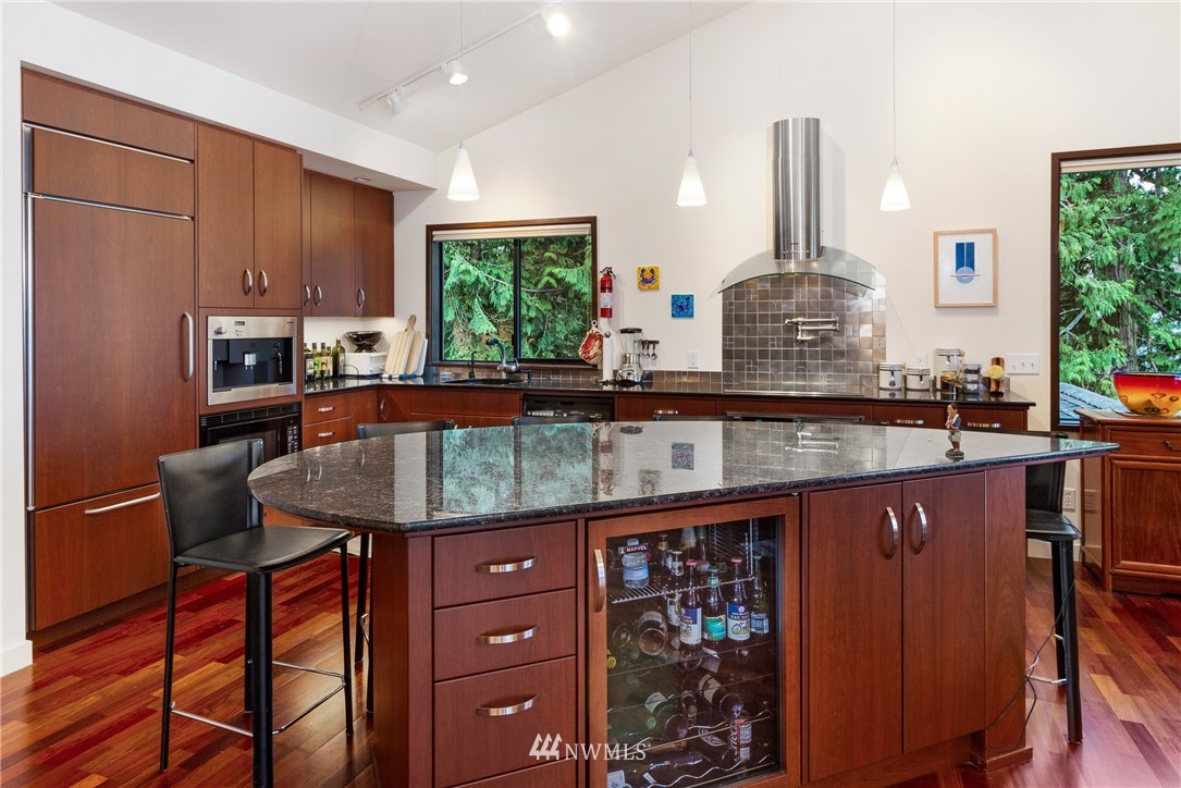 184 Armadale Road, Unit 5 Friday Harbor, WA 98250 - Photo 6 of 23 a kitchen with granite countertop a sink a counter space appliances and cabinets