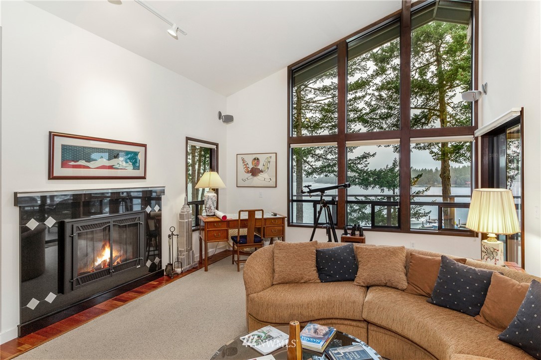 184 Armadale Road, Unit 5 Friday Harbor, WA 98250 - Photo 7 of 23 a living room with furniture a large window and a fireplace