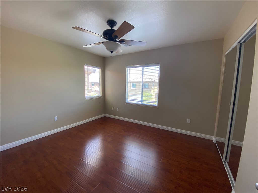 489 Foster Springs Road Las Vegas, NV 89148 - Photo 16 of 30 Rich hardwood floors create a welcoming atmosphere in this spacious bedroom.