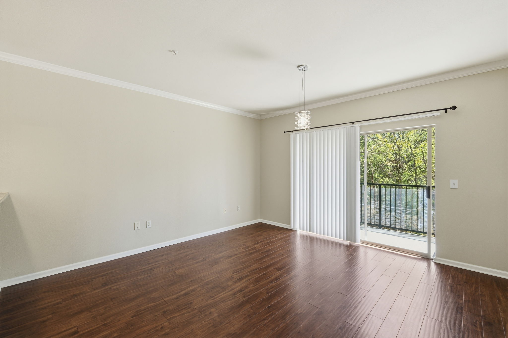 11203 Ranch Road 2222, Unit 2305 Austin, TX 78732 - Photo 3 of 19 Unfurnished room with crown molding, dark wood finished floors, and suspended lighting