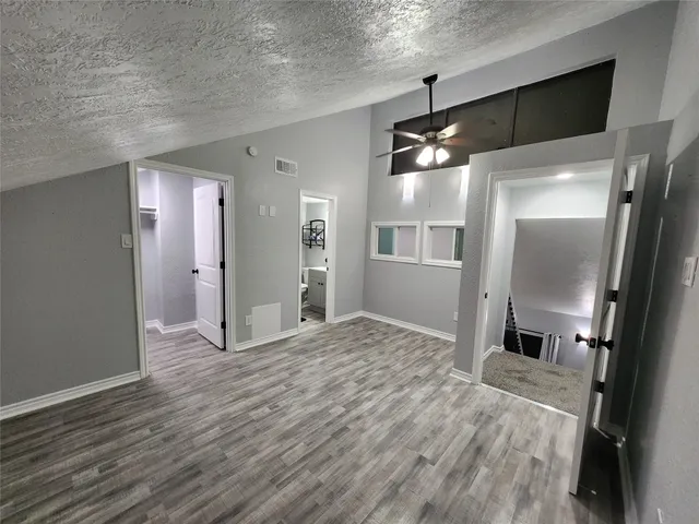 a view of a kitchen with a sink and refrigerator
