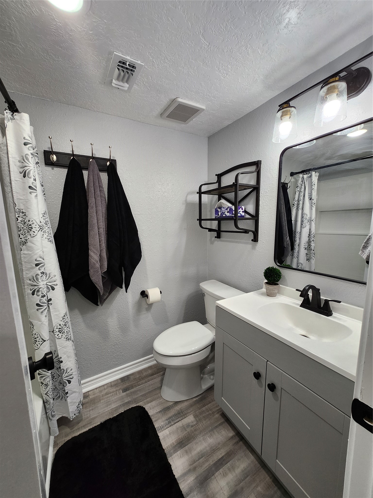 12900 Walden Road, Unit 314C Montgomery, TX 77356 - Photo 15 of 20 a bathroom with a sink toilet and mirror