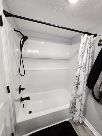 a bathroom with a bathtub and a shower