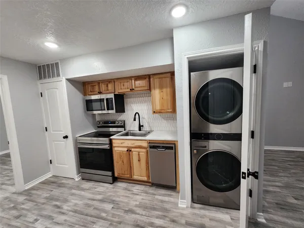 a view of a kitchen with washer and dryer
