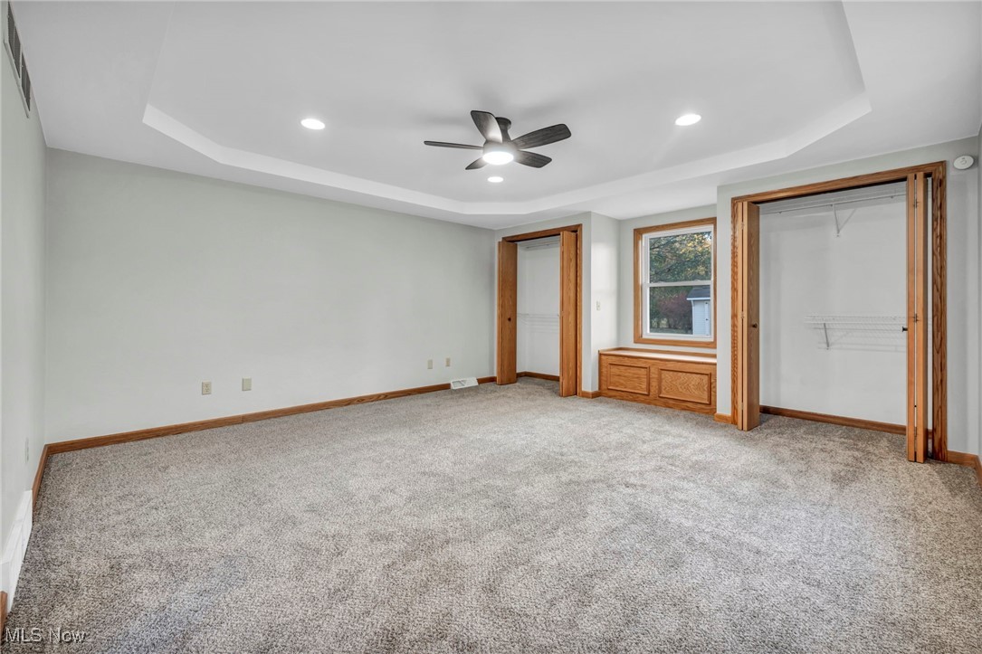 503 Churchill Road Youngstown, OH 44505 - Photo 7 of 32 bedroom featuring a tray ceiling, recessed lighting, light colored carpet, ceiling fan, and multiple closets