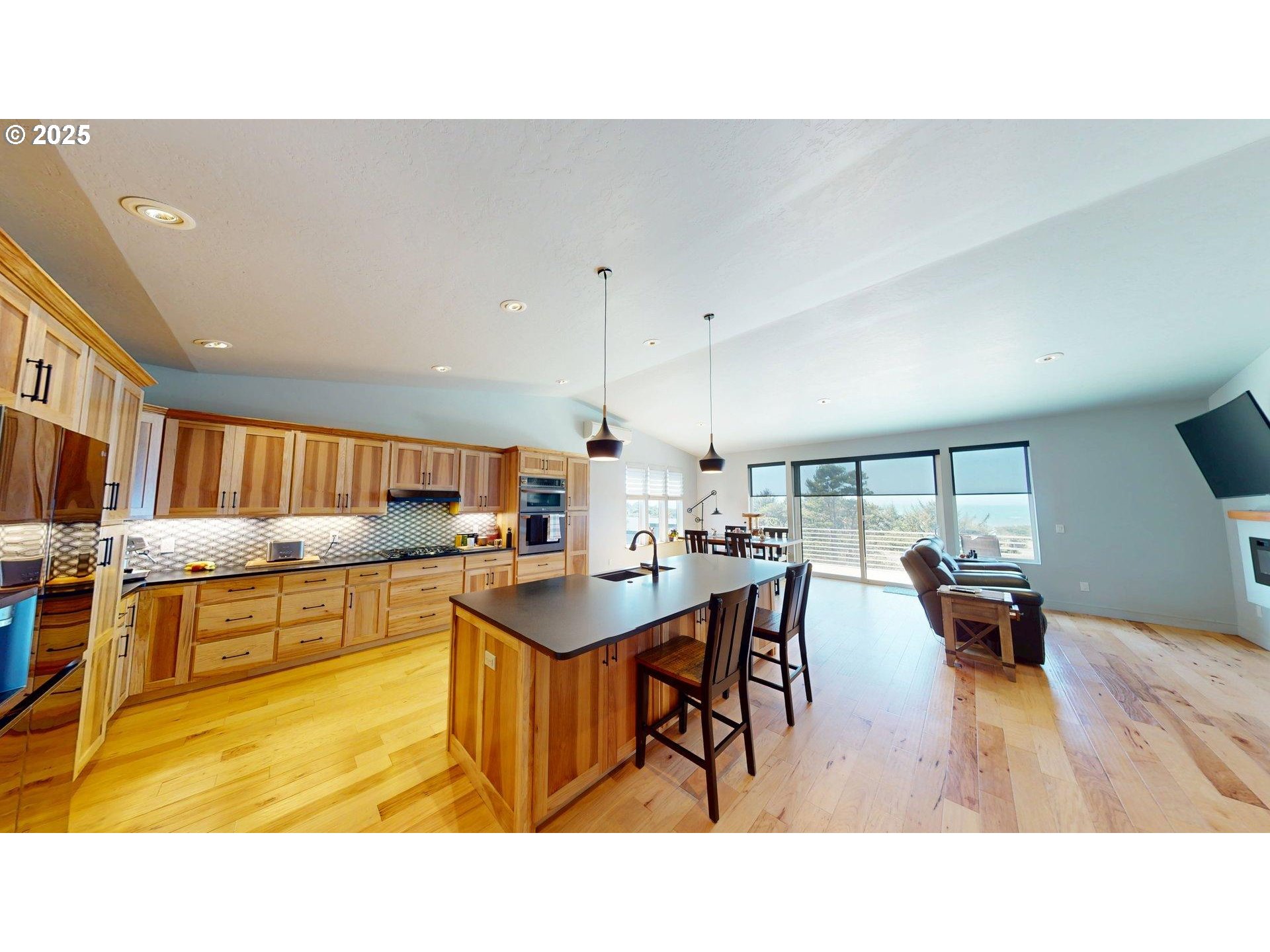 30420 Sawyer Way Gold Beach, OR 97444 - Photo 12 of 47 a kitchen with kitchen island a stove a table and chairs in it
