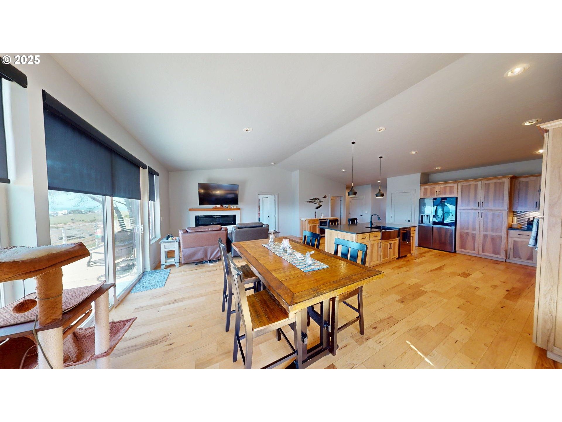 30420 Sawyer Way Gold Beach, OR 97444 - Photo 13 of 47 a living room with stainless steel appliances kitchen island a table and chairs in it
