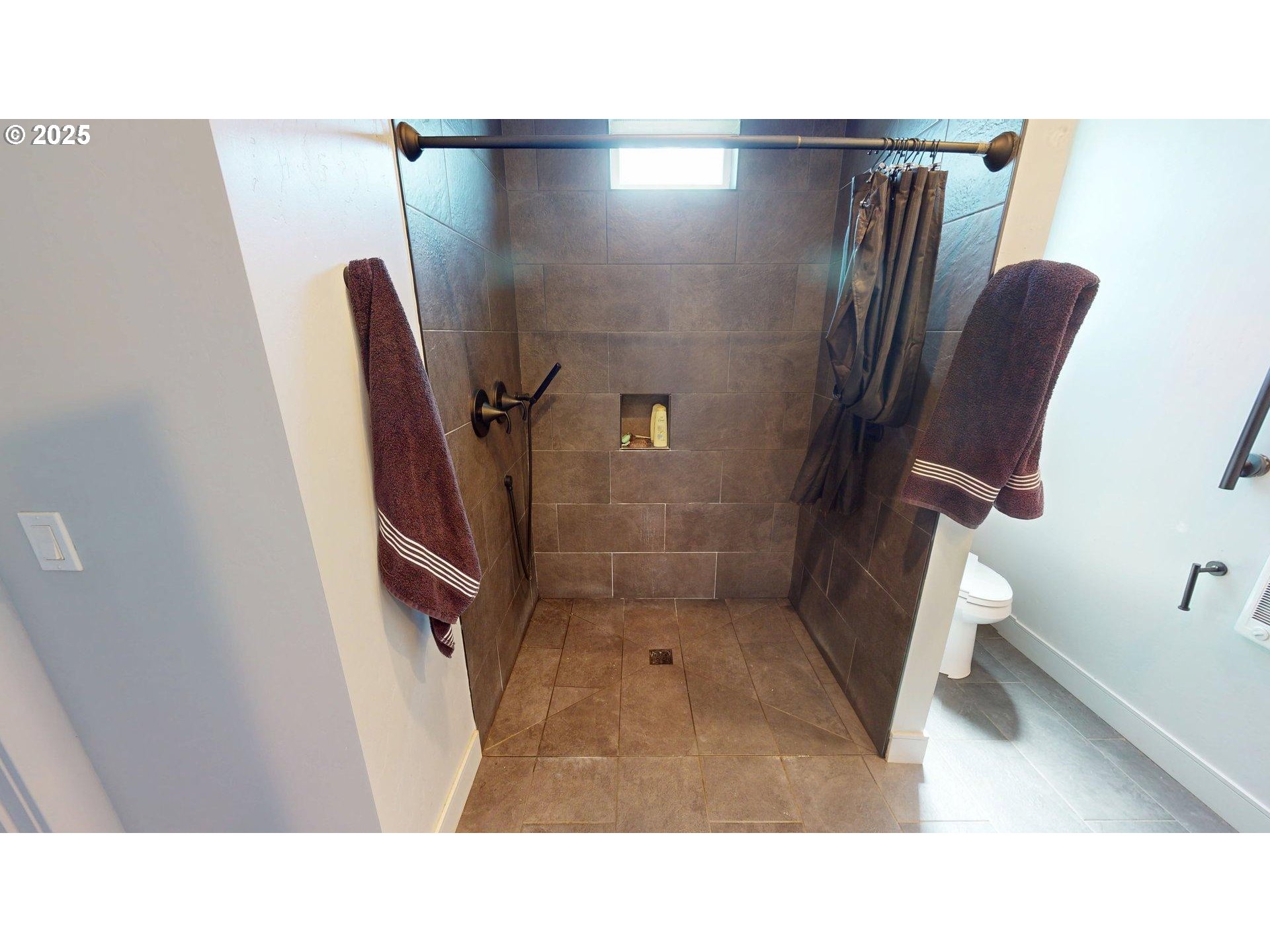 30420 Sawyer Way Gold Beach, OR 97444 - Photo 23 of 47 a bathroom with a sink mirror toilet and shower