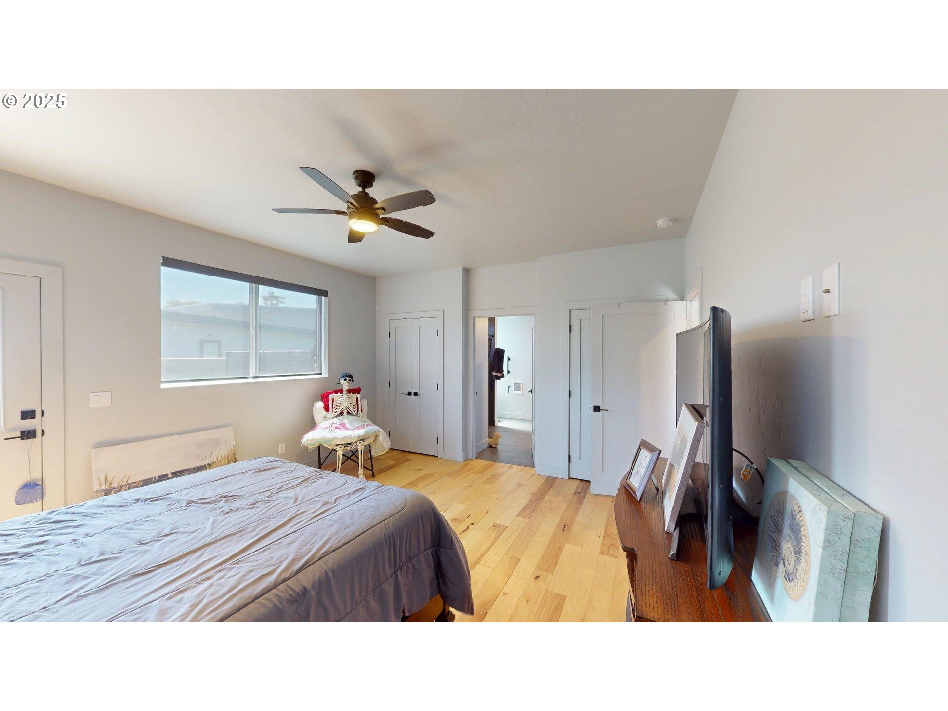 30420 Sawyer Way Gold Beach, OR 97444 - Photo 28 of 47 a bedroom with a bed and a flat tv screen on the dresser