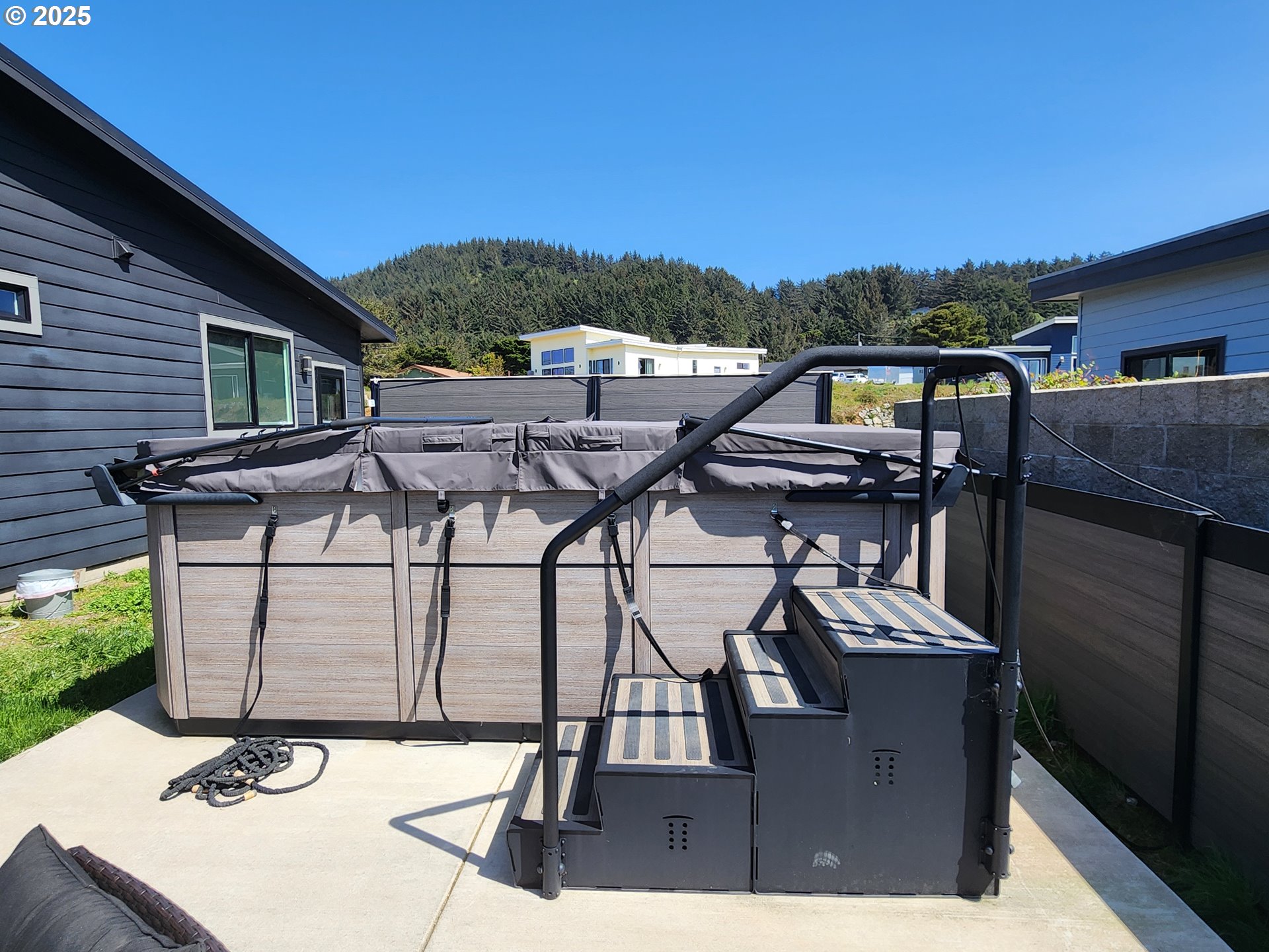 30420 Sawyer Way Gold Beach, OR 97444 - Photo 4 of 47 a view of a patio with table and chairs with wooden floor and fence