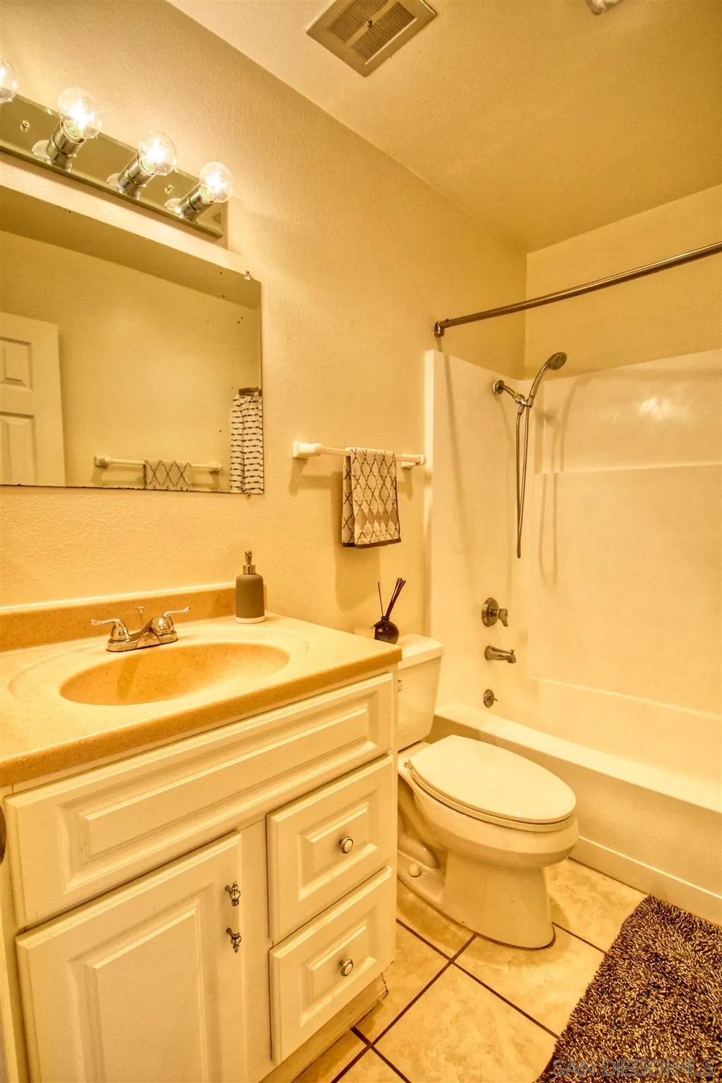 6069 Rancho Mission Road, Unit 202 San Diego, CA 92108 - Photo 15 of 26 a bathroom with a sink a toilet and shower