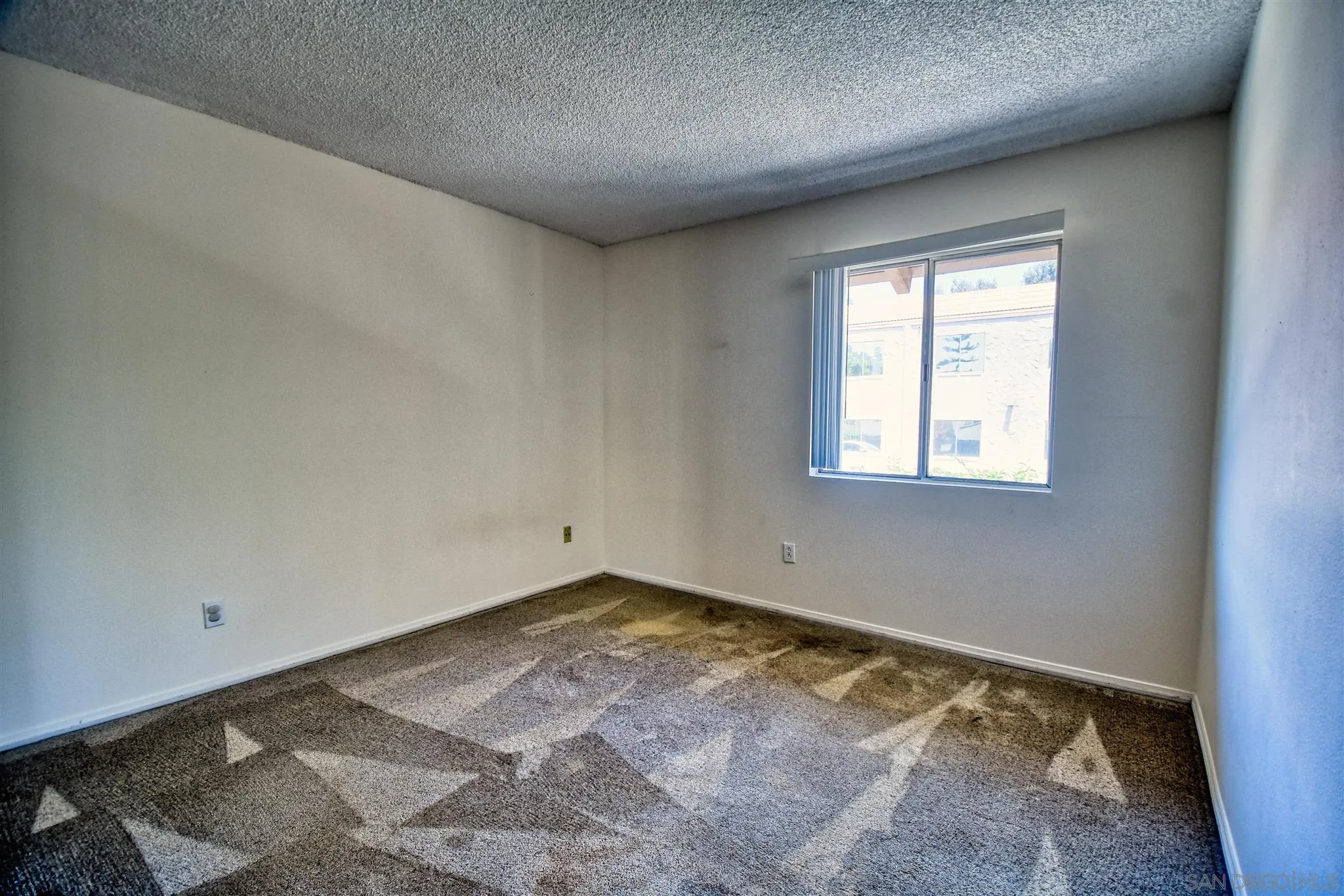 6069 Rancho Mission Road, Unit 202 San Diego, CA 92108 - Photo 16 of 26 an empty room with a window
