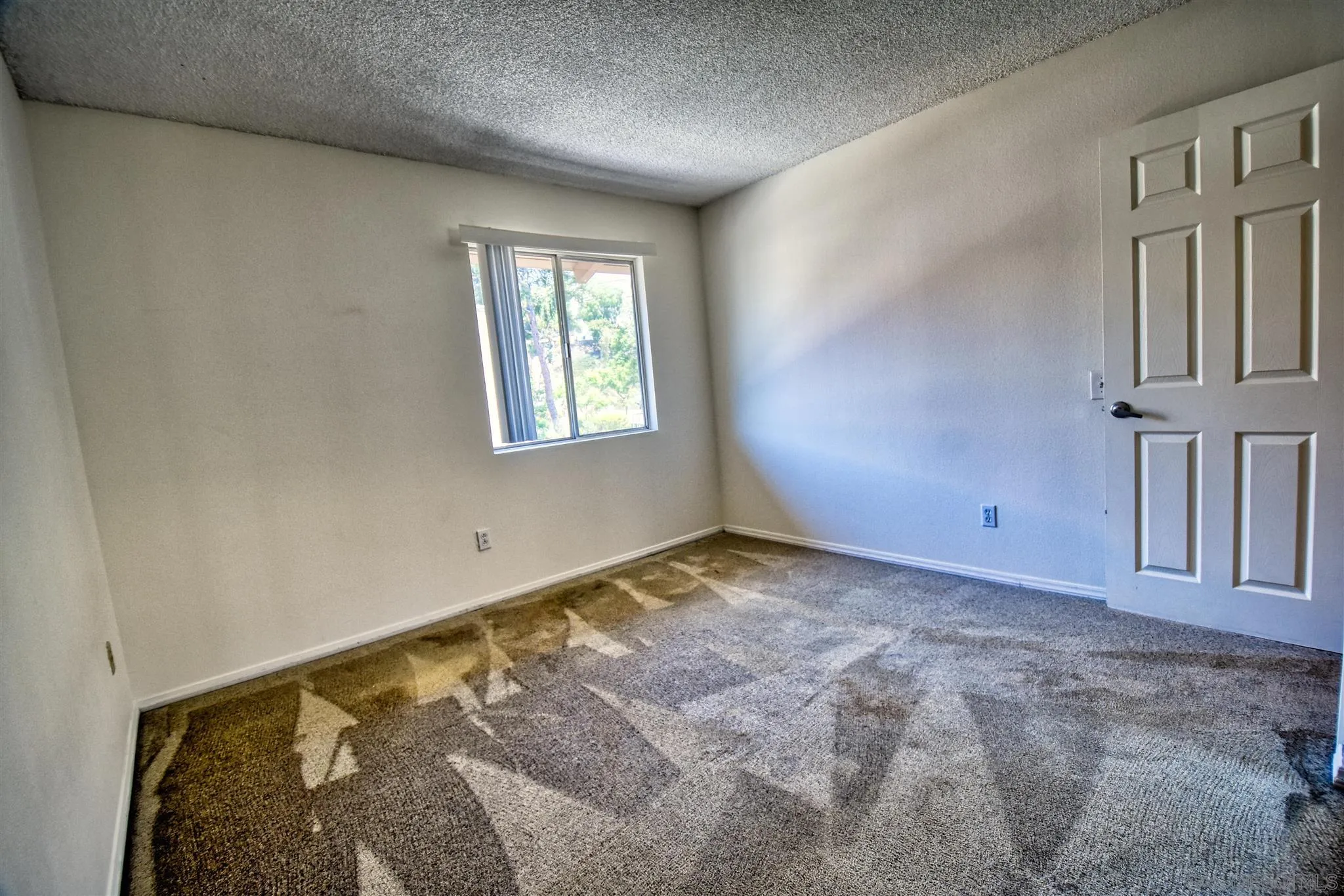 6069 Rancho Mission Road, Unit 202 San Diego, CA 92108 - Photo 17 of 26 a view of an empty room and window