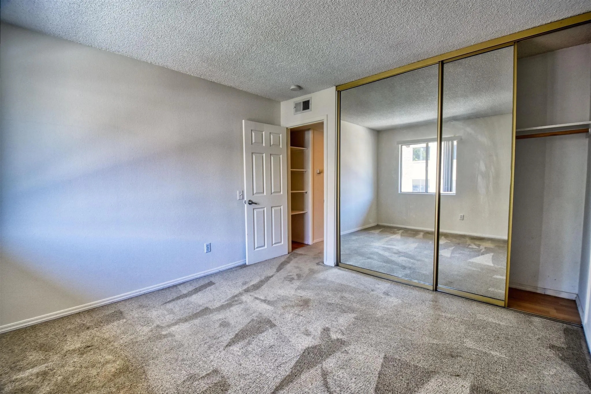 6069 Rancho Mission Road, Unit 202 San Diego, CA 92108 - Photo 18 of 26 an empty room with windows