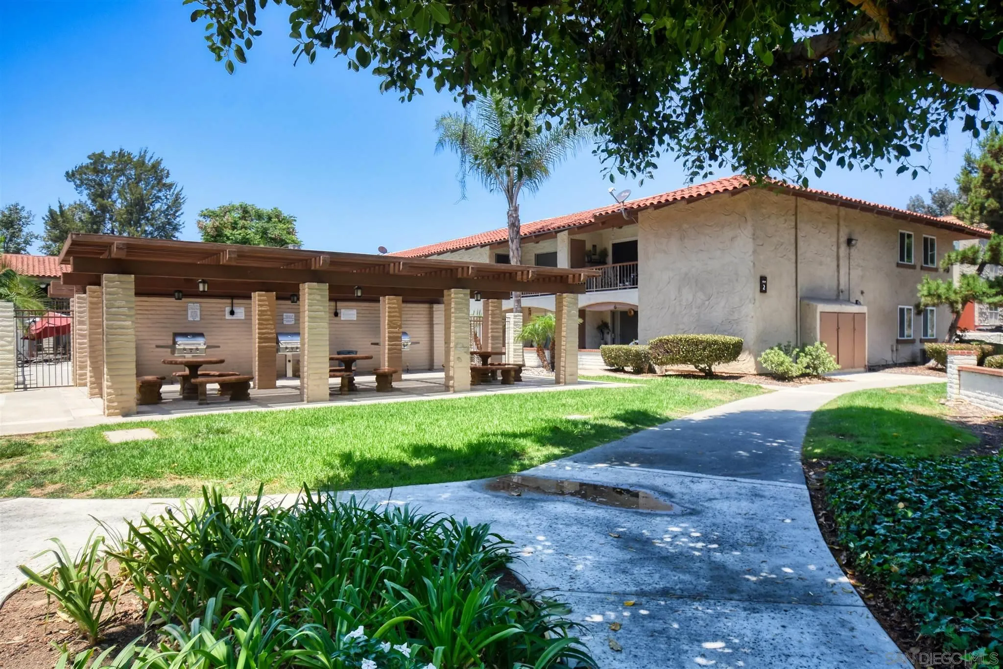 6069 Rancho Mission Road, Unit 202 San Diego, CA 92108 - Photo 23 of 26 a front view of a house with garden