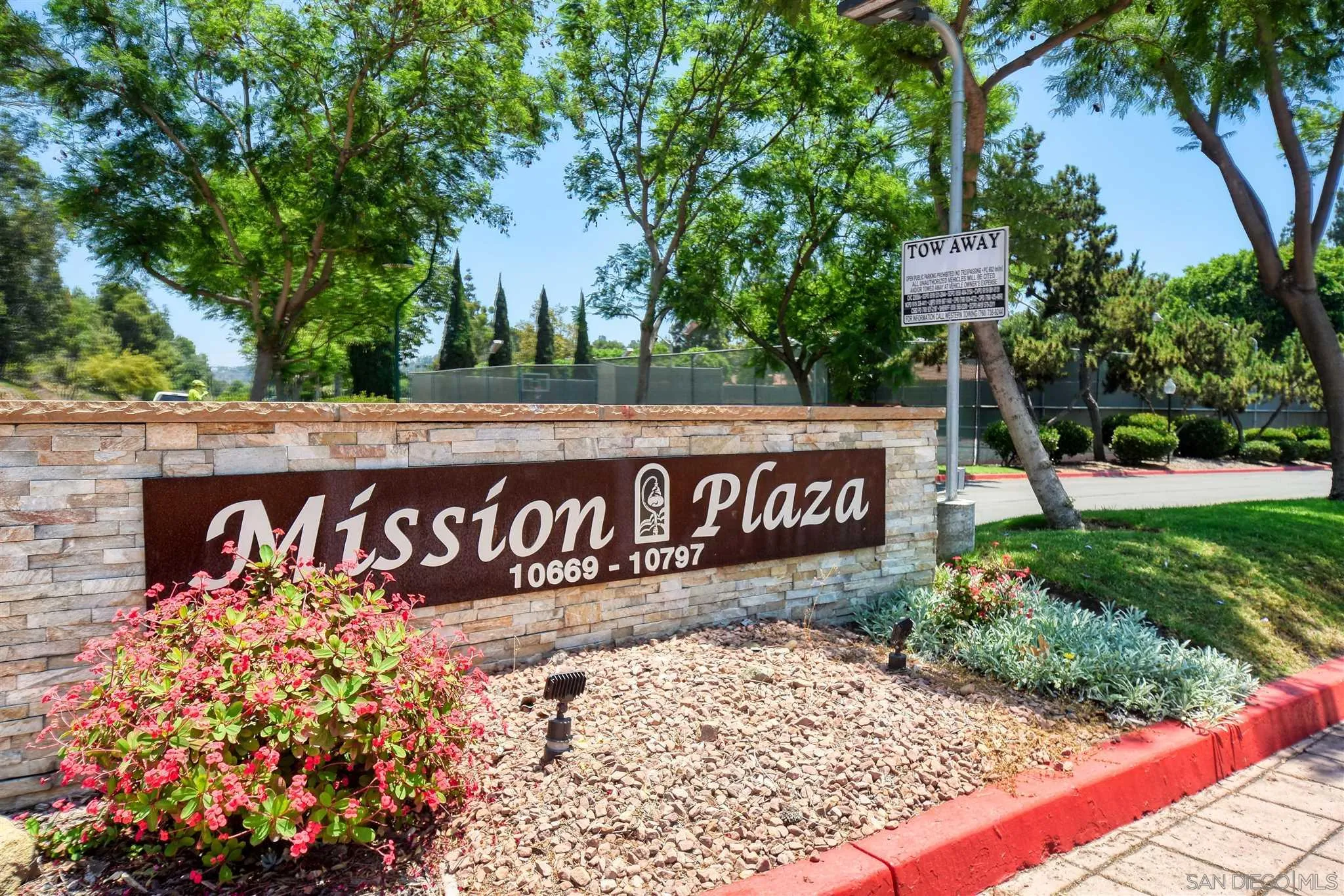 6069 Rancho Mission Road, Unit 202 San Diego, CA 92108 - Photo 25 of 26 a street sign on a wall next to a road