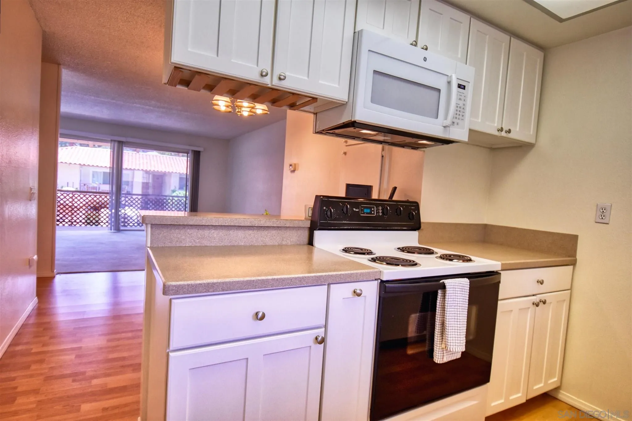 6069 Rancho Mission Road, Unit 202 San Diego, CA 92108 - Photo 3 of 26 a kitchen with stainless steel appliances granite countertop a sink stove and cabinets