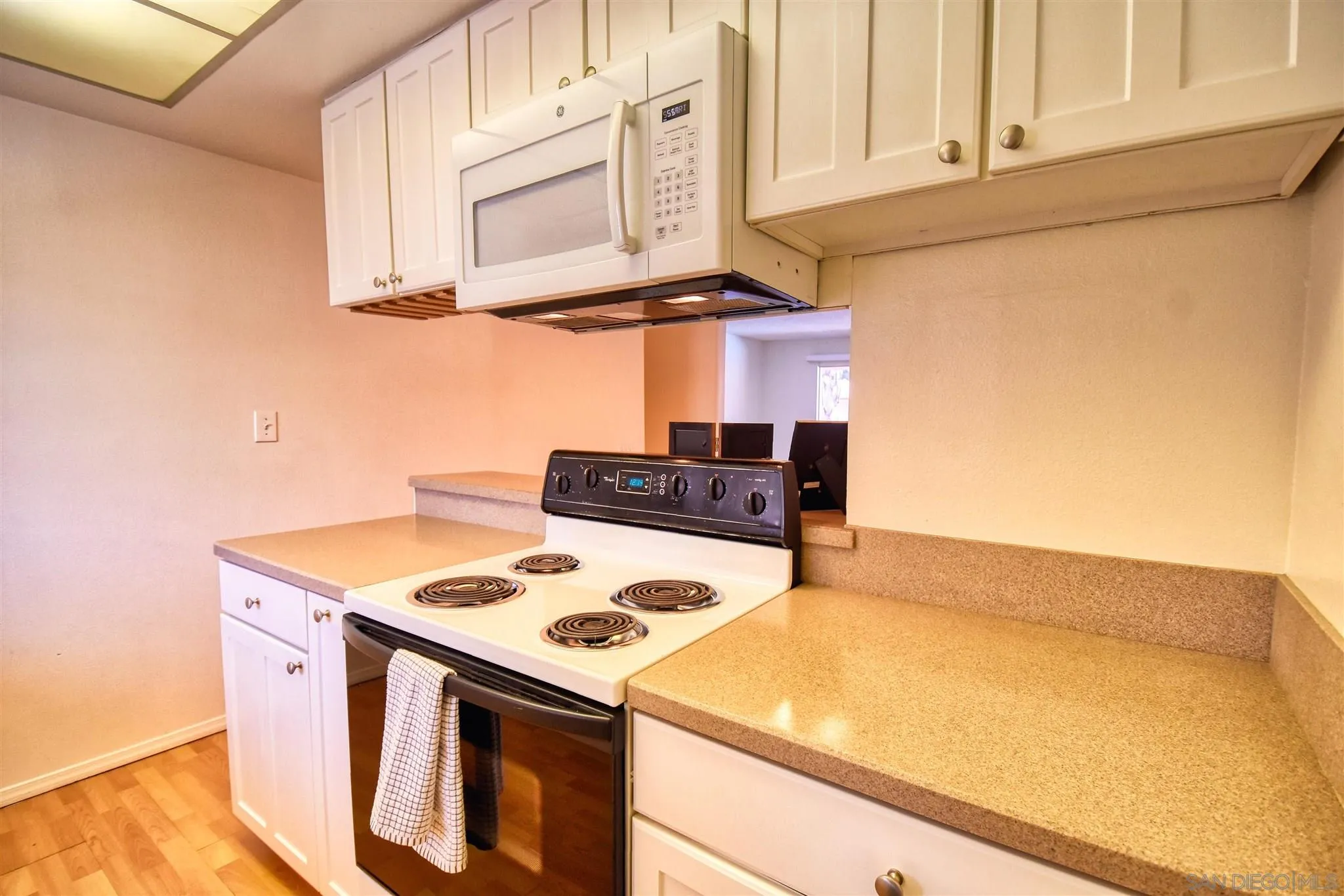 6069 Rancho Mission Road, Unit 202 San Diego, CA 92108 - Photo 5 of 26 a kitchen with a stove and a microwave