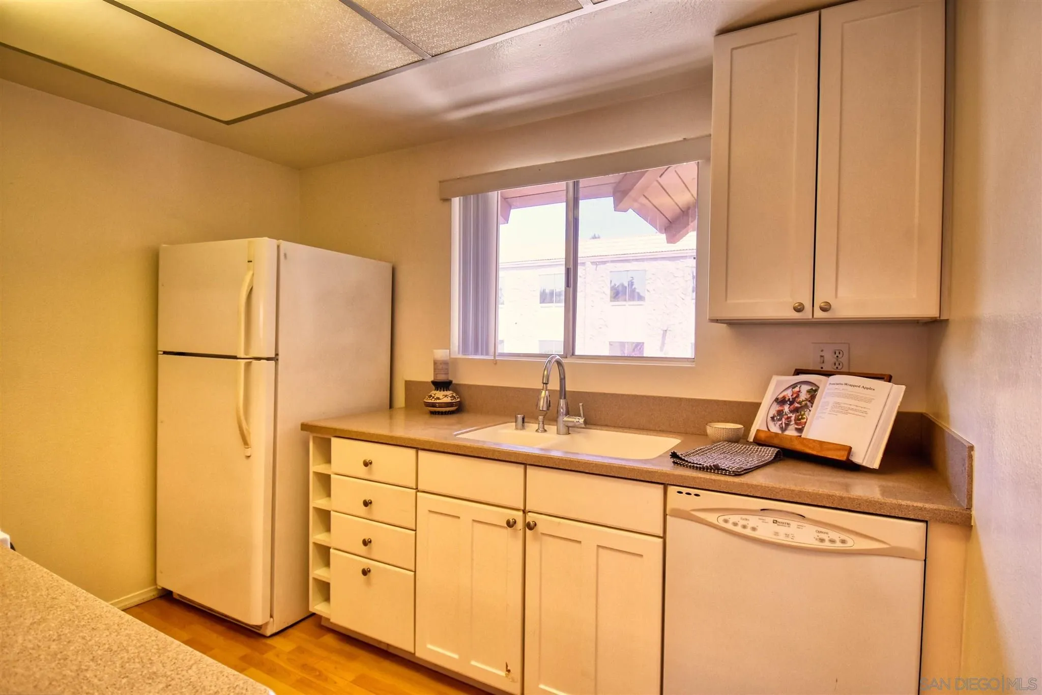 6069 Rancho Mission Road, Unit 202 San Diego, CA 92108 - Photo 7 of 26 a kitchen with appliances a sink and a window