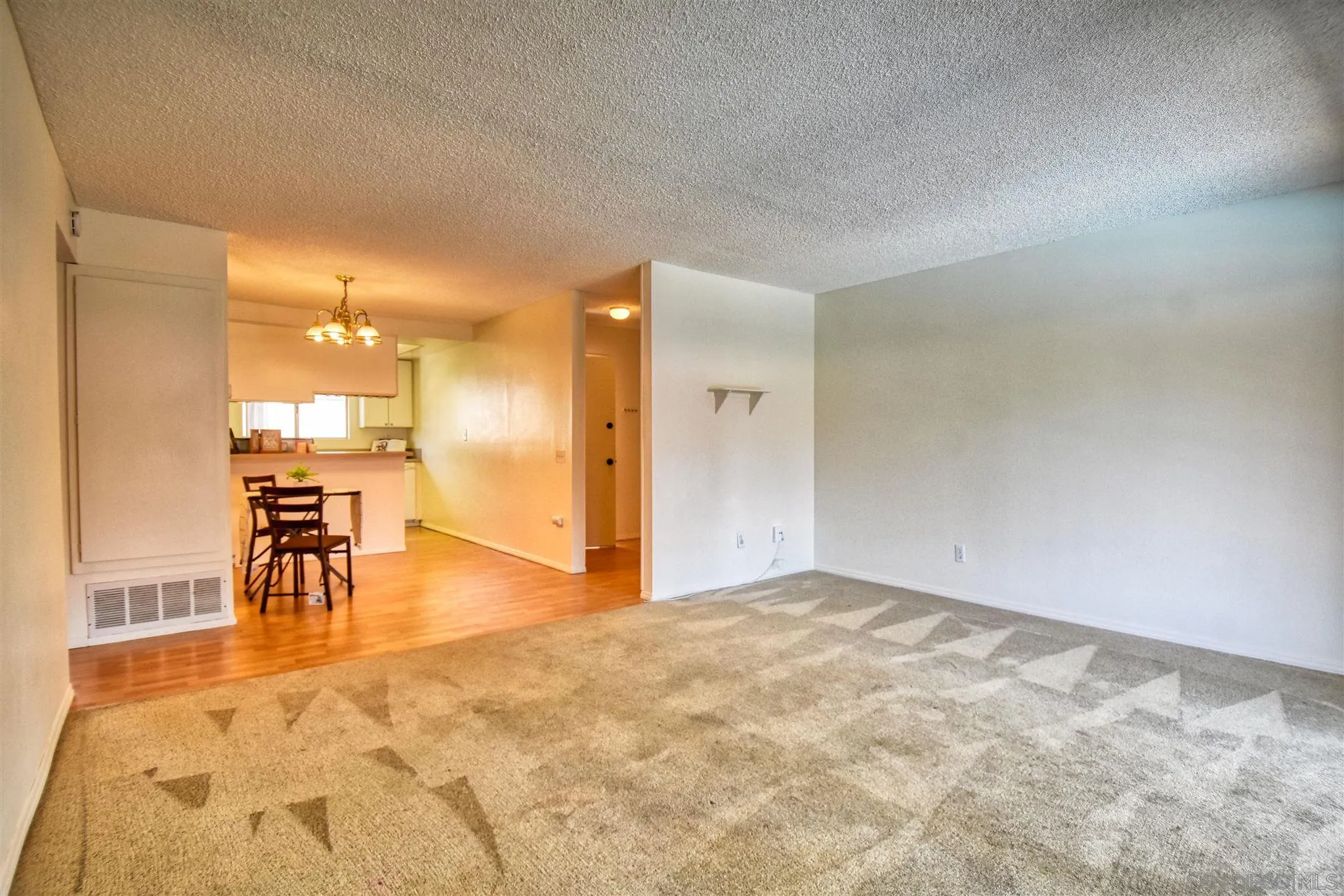 6069 Rancho Mission Road, Unit 202 San Diego, CA 92108 - Photo 10 of 26 a view of a livingroom and a kitchen with furniture