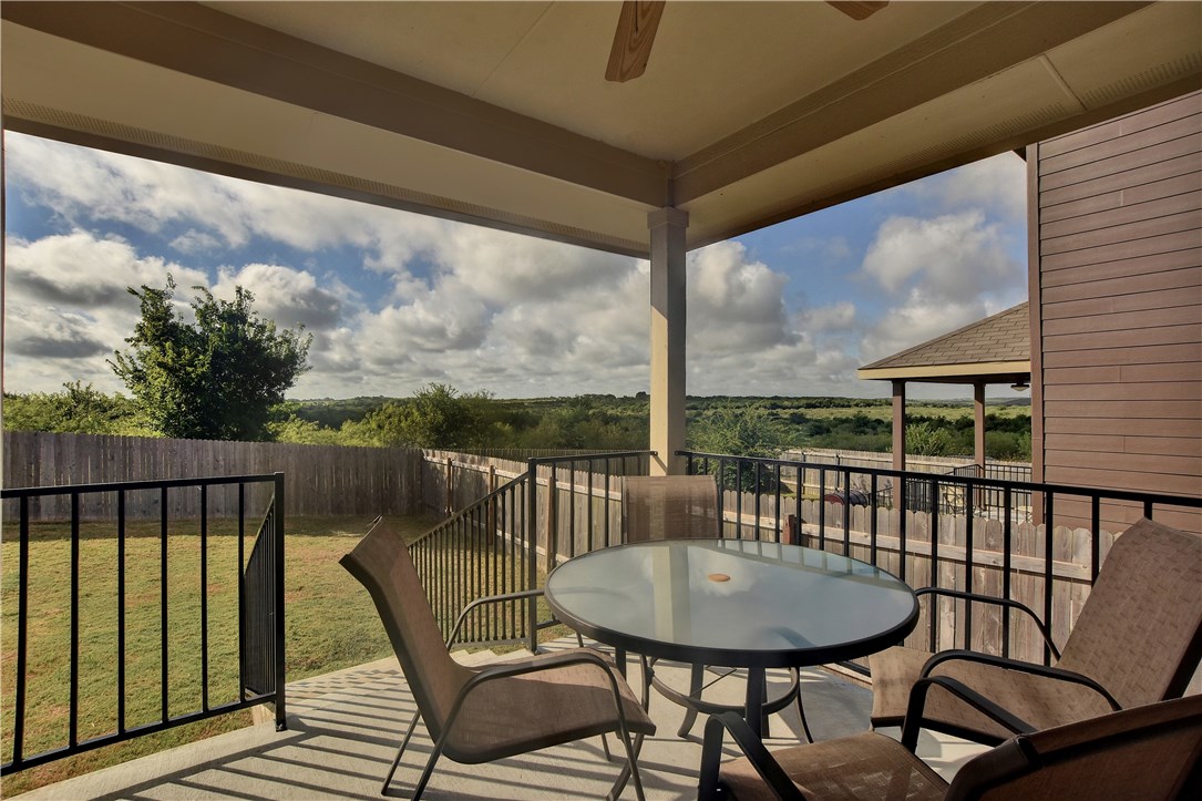a view of a balcony with a table and chairs
