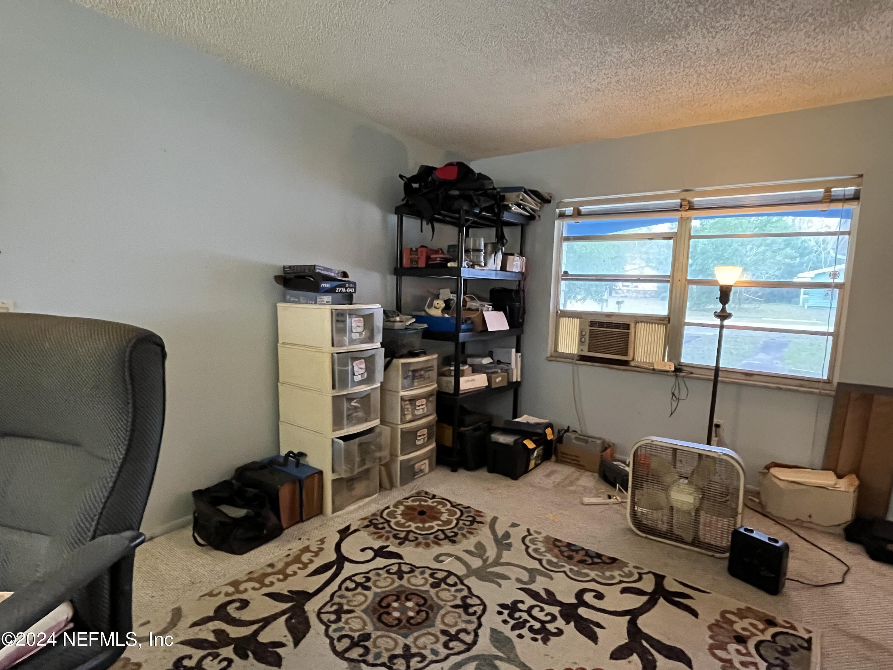 228 Lily Road St. Augustine, FL 32086 - Photo 14 of 34 a bedroom with a bed and a window