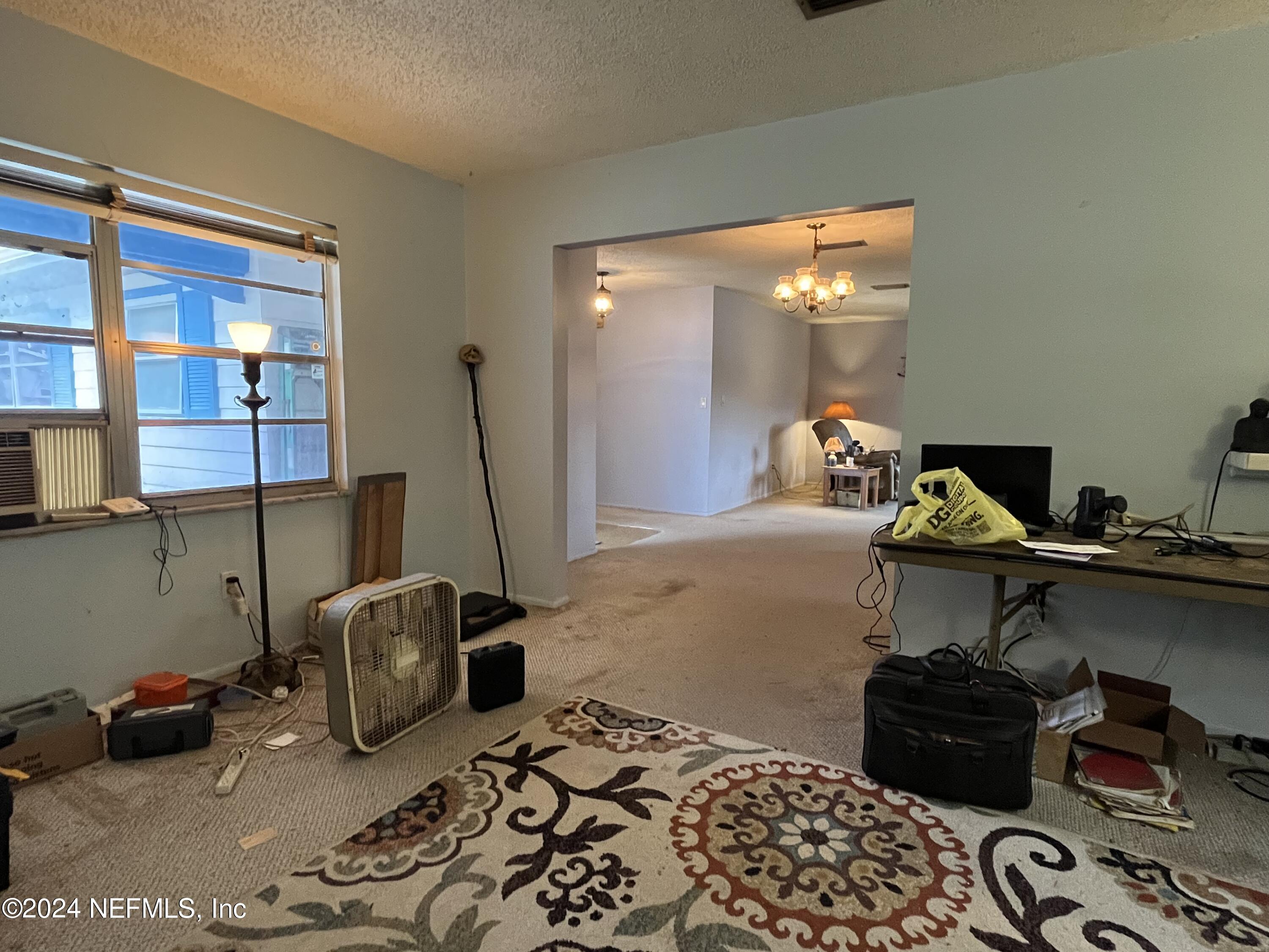 228 Lily Road St. Augustine, FL 32086 - Photo 15 of 34 a bedroom with furniture and a window