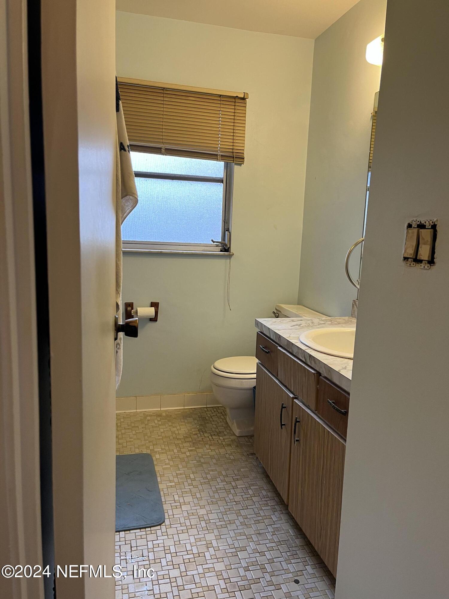 228 Lily Road St. Augustine, FL 32086 - Photo 20 of 34 a bathroom with a sink and a toilet