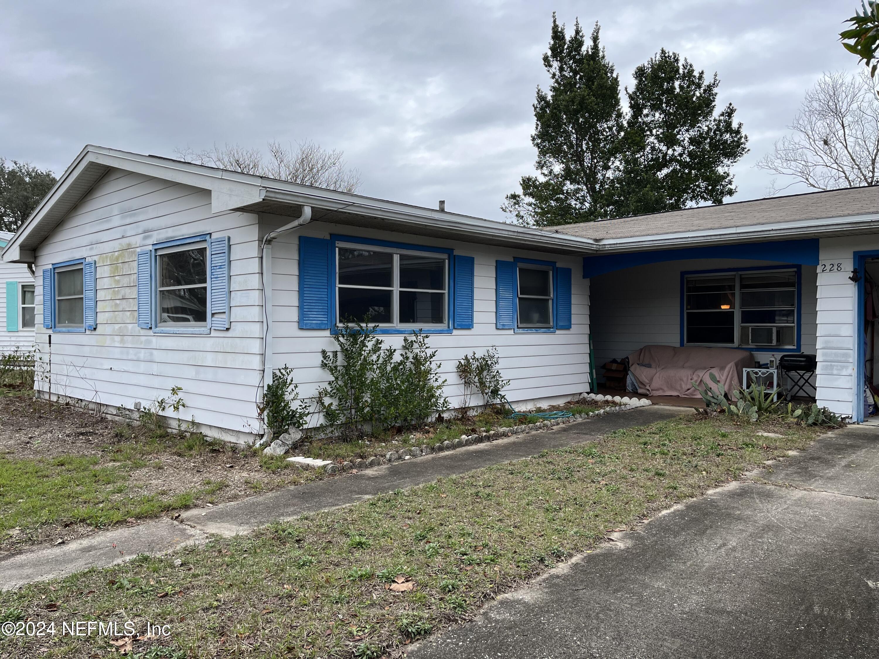 228 Lily Road St. Augustine, FL 32086 - Photo 2 of 34 a front view of a house with garden