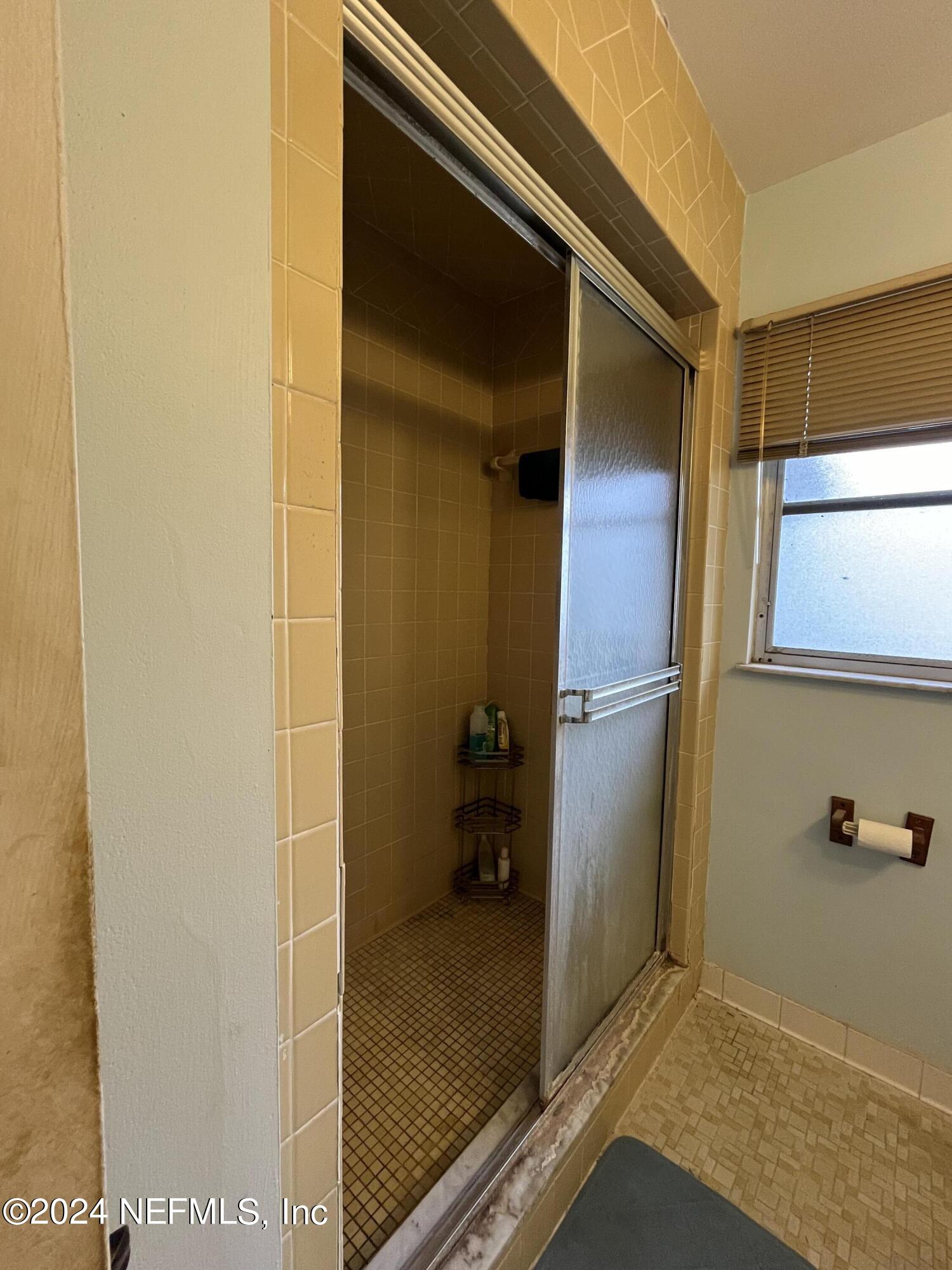 228 Lily Road St. Augustine, FL 32086 - Photo 21 of 34 a bathroom with a shower and a sink