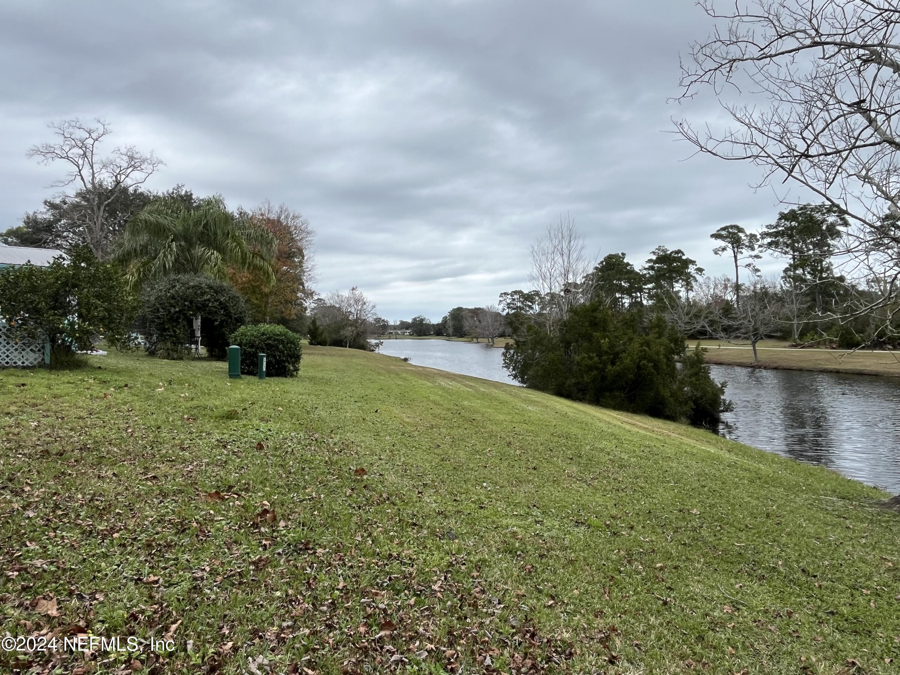 228 Lily Road St. Augustine, FL 32086 - Photo 33 of 34 a view of a lake with a yard
